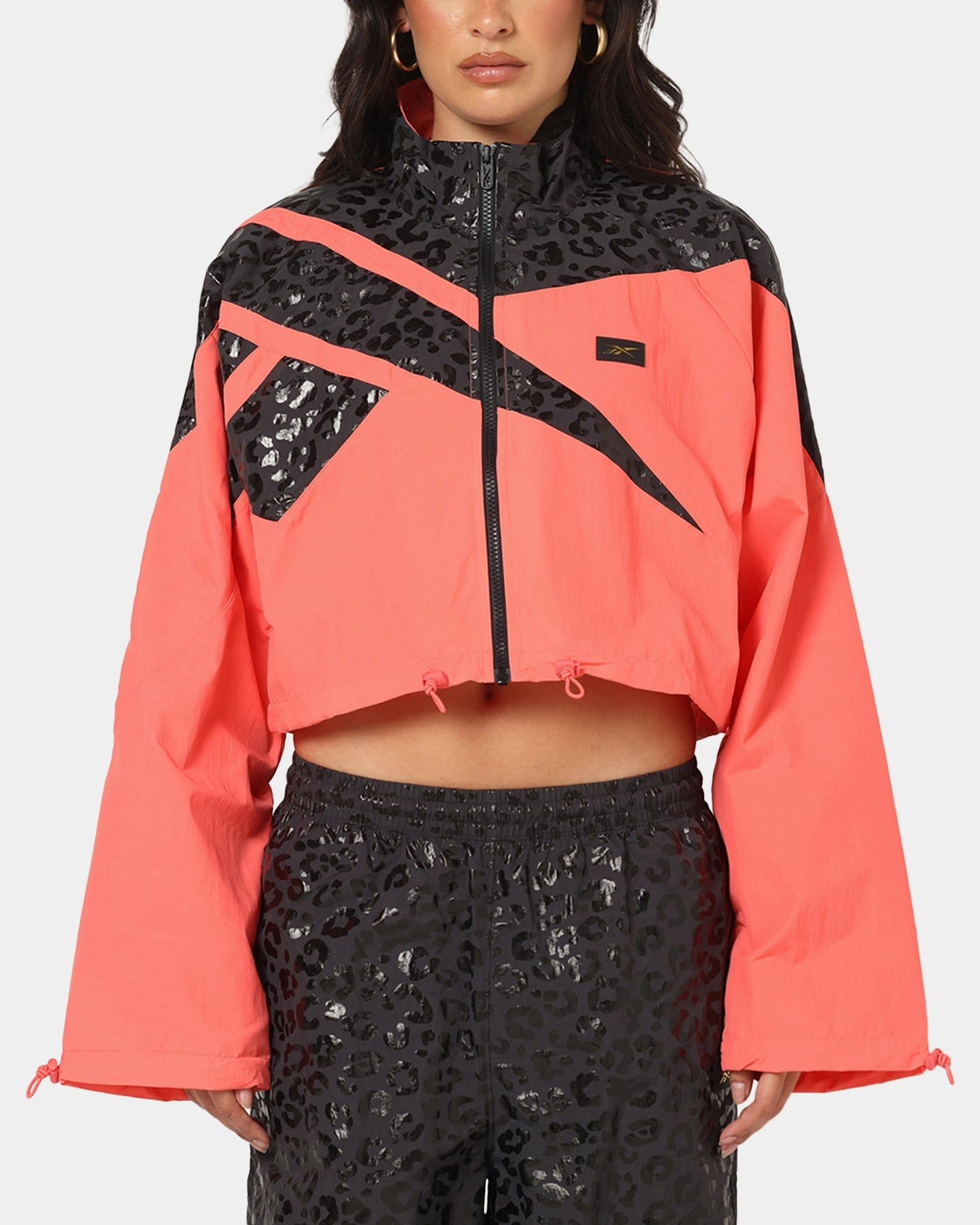 Slim Profile Reebok X Angel Reese Women's Vector Track Jacket Coral